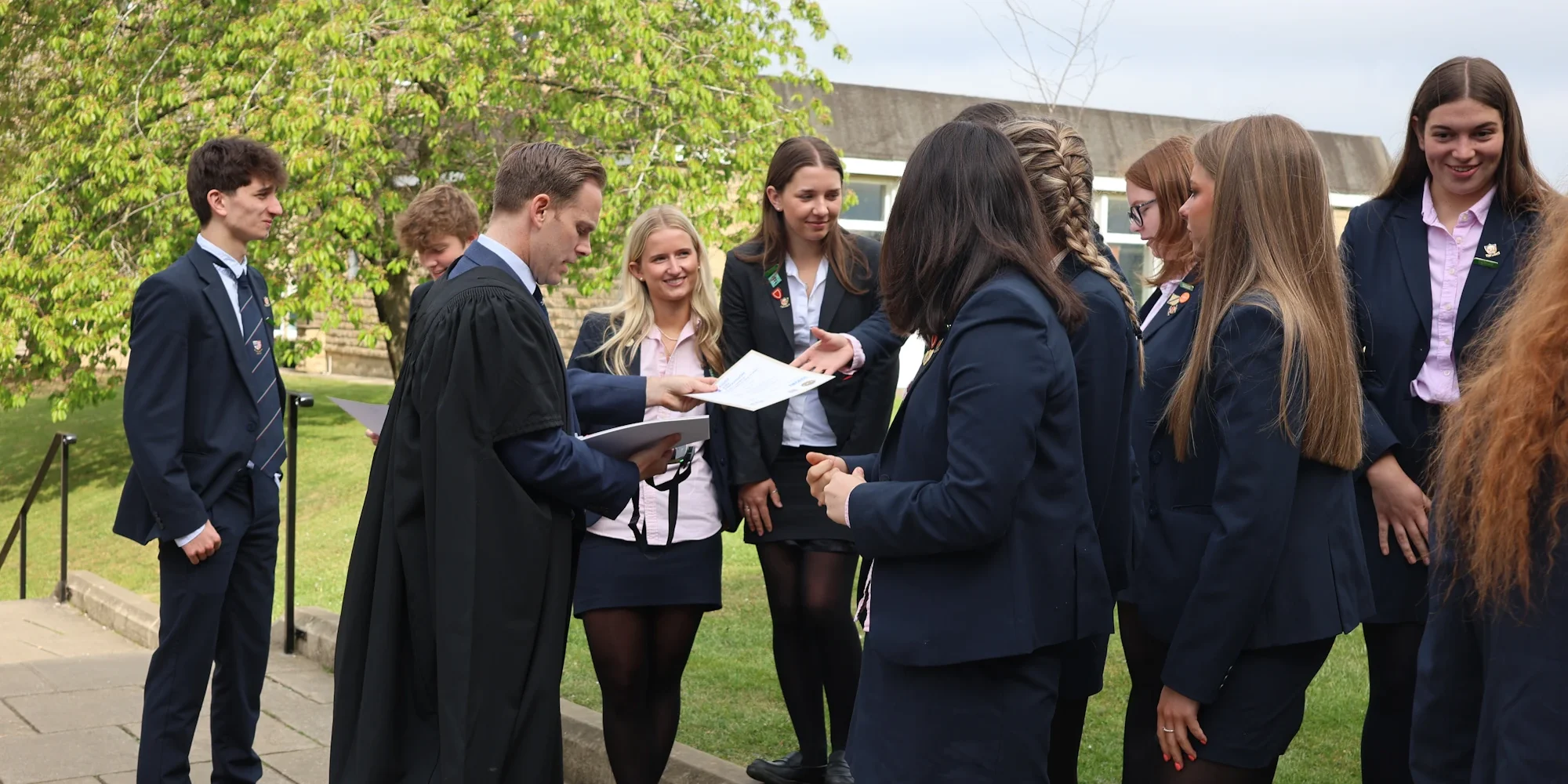 Barnard Castle School pupils getting handed A Level result certificates from Headmaster David Cresswell.