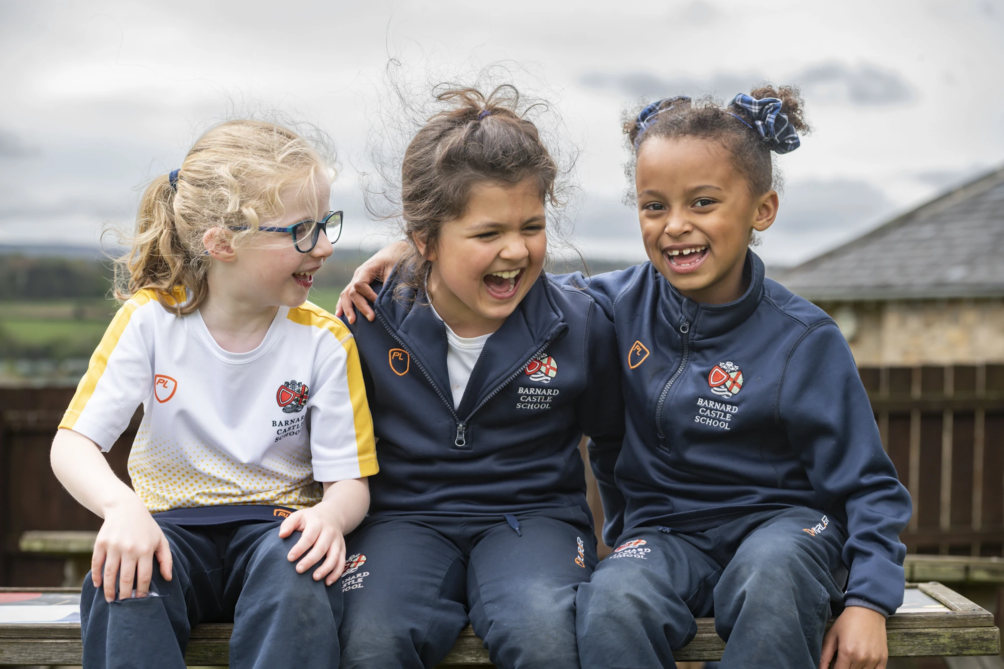 Three Barnard Castle School Prep pupils sat today hugging and smiling.