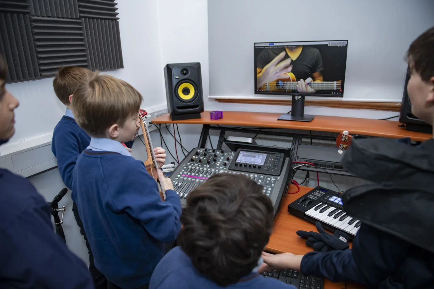 Barnard Castle School pupils learning how to play ukeleles.