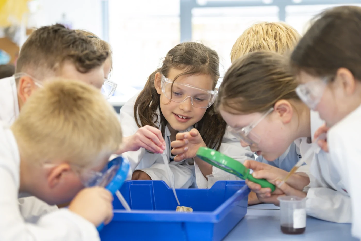 Prep school years 3 to 6 conducting a science experiment.
