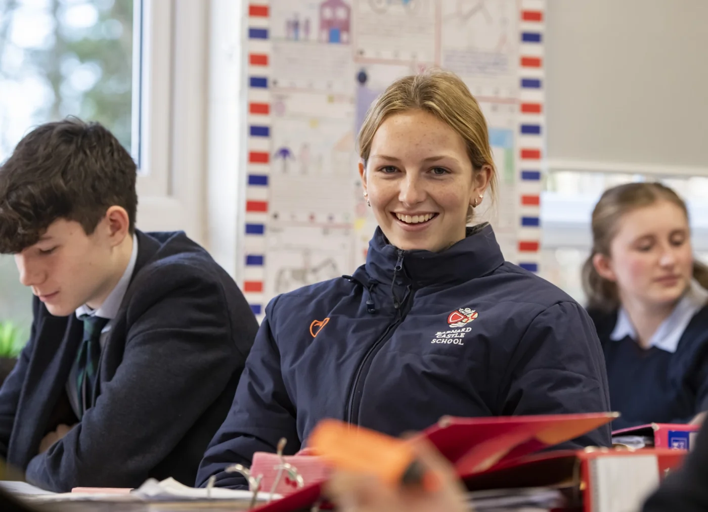 Student in classroom sat alongside peers.