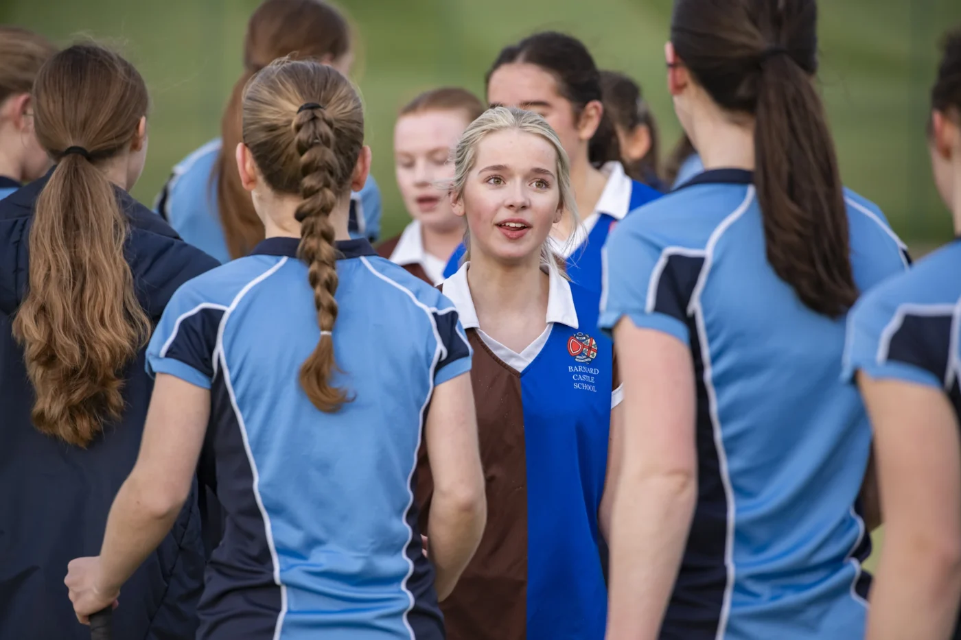 Senior school students getting ready to play hockey.