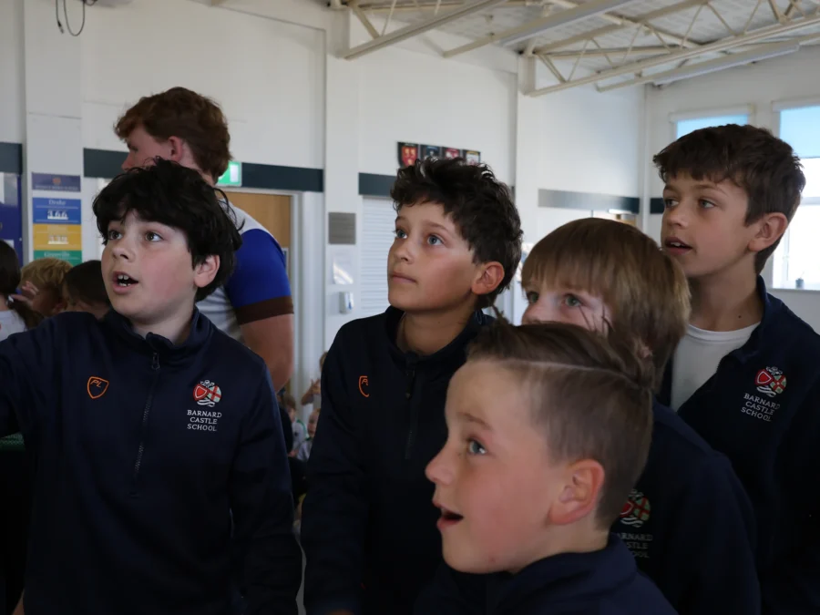 Barnard Castle School pupils looking at a board together,