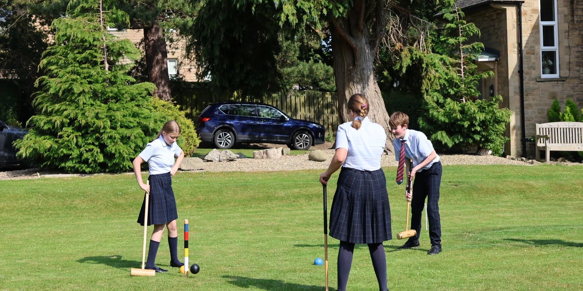 Barney students outdoor playing croquet.