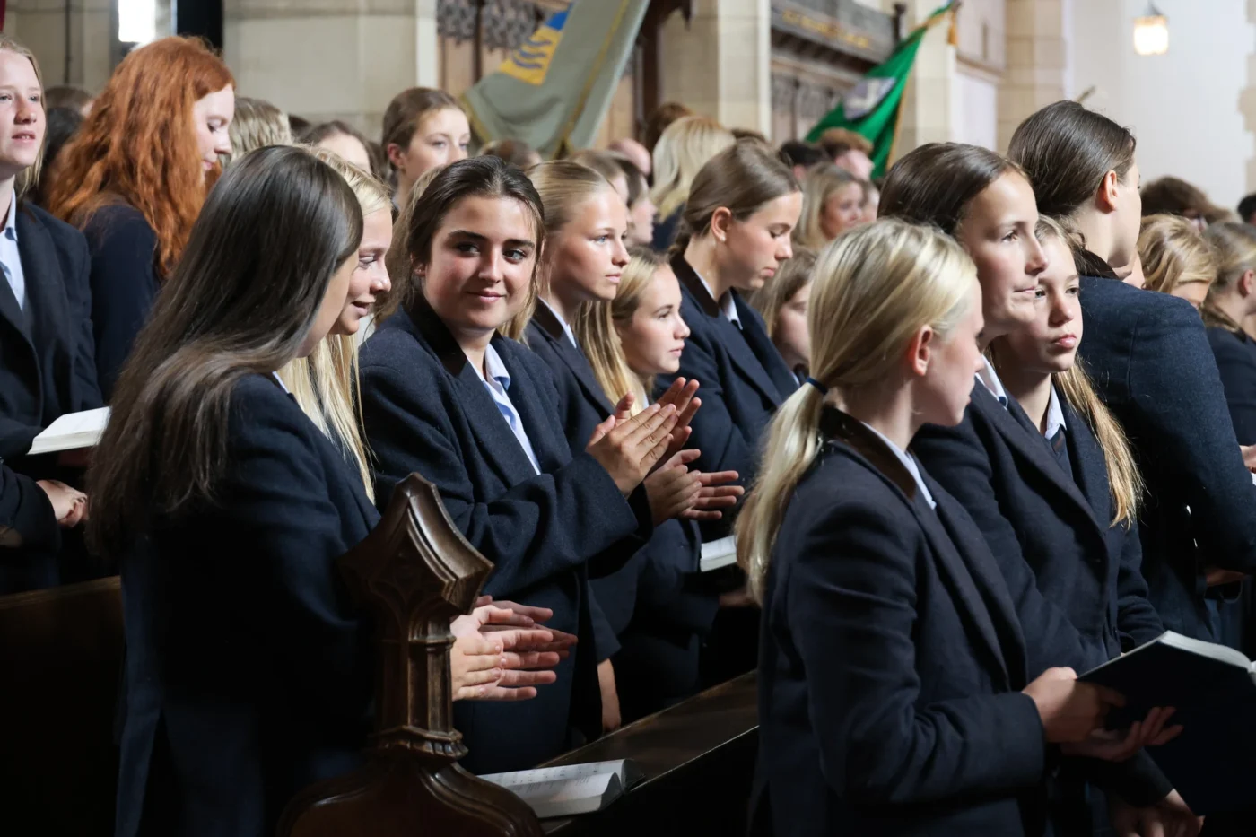 Barney students applauding in an assembly.
