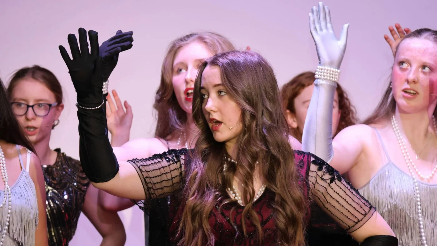 Barney students in period costume singing.