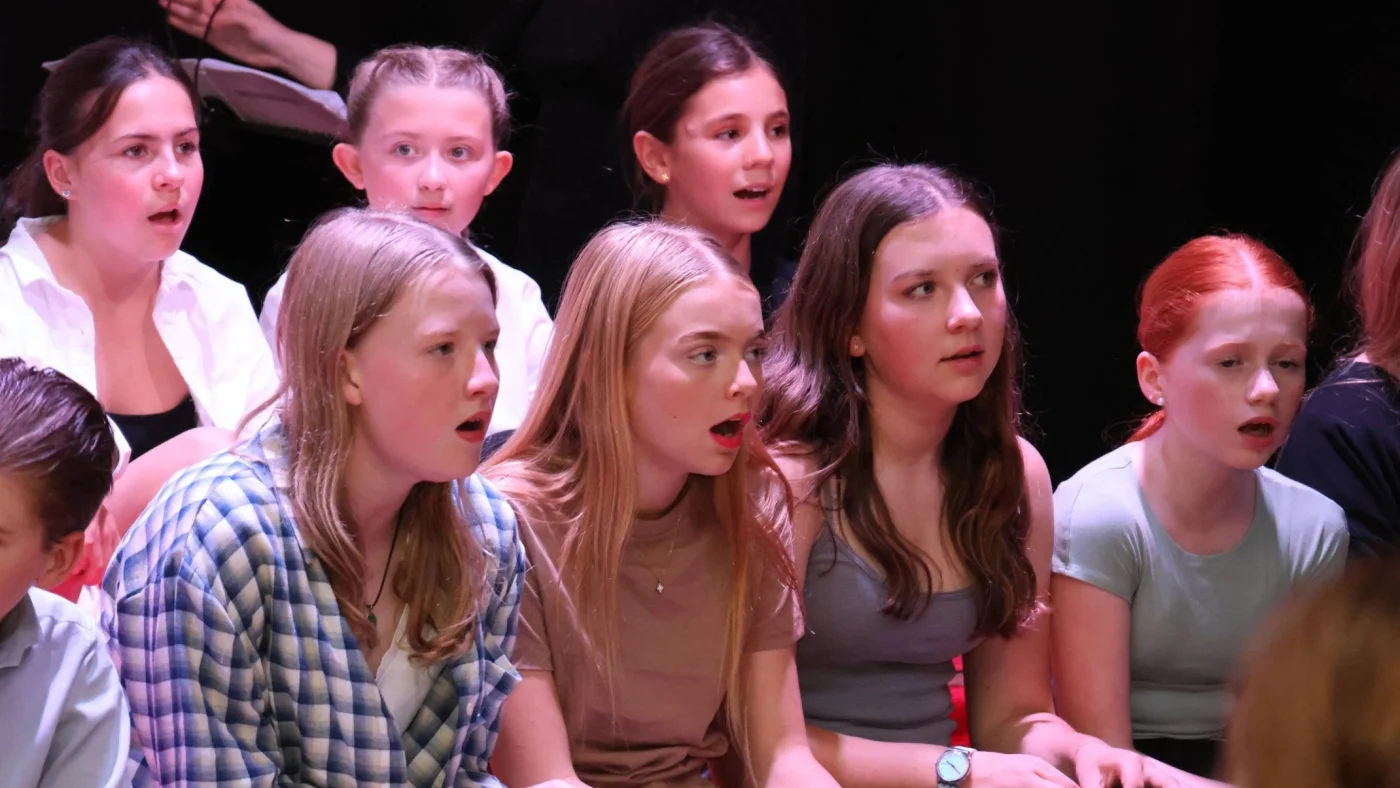A group of Barney girls singing during Bugsy Malone.