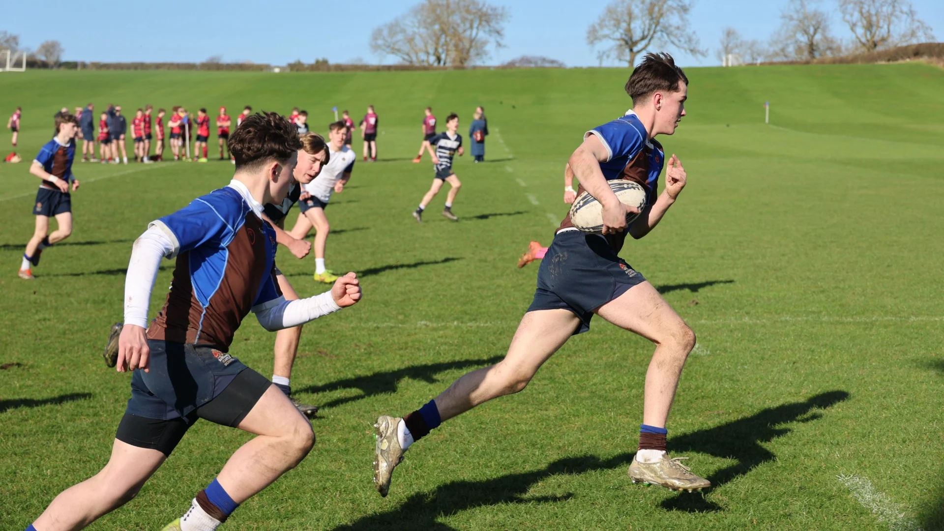Barney rugby players running during a training session.